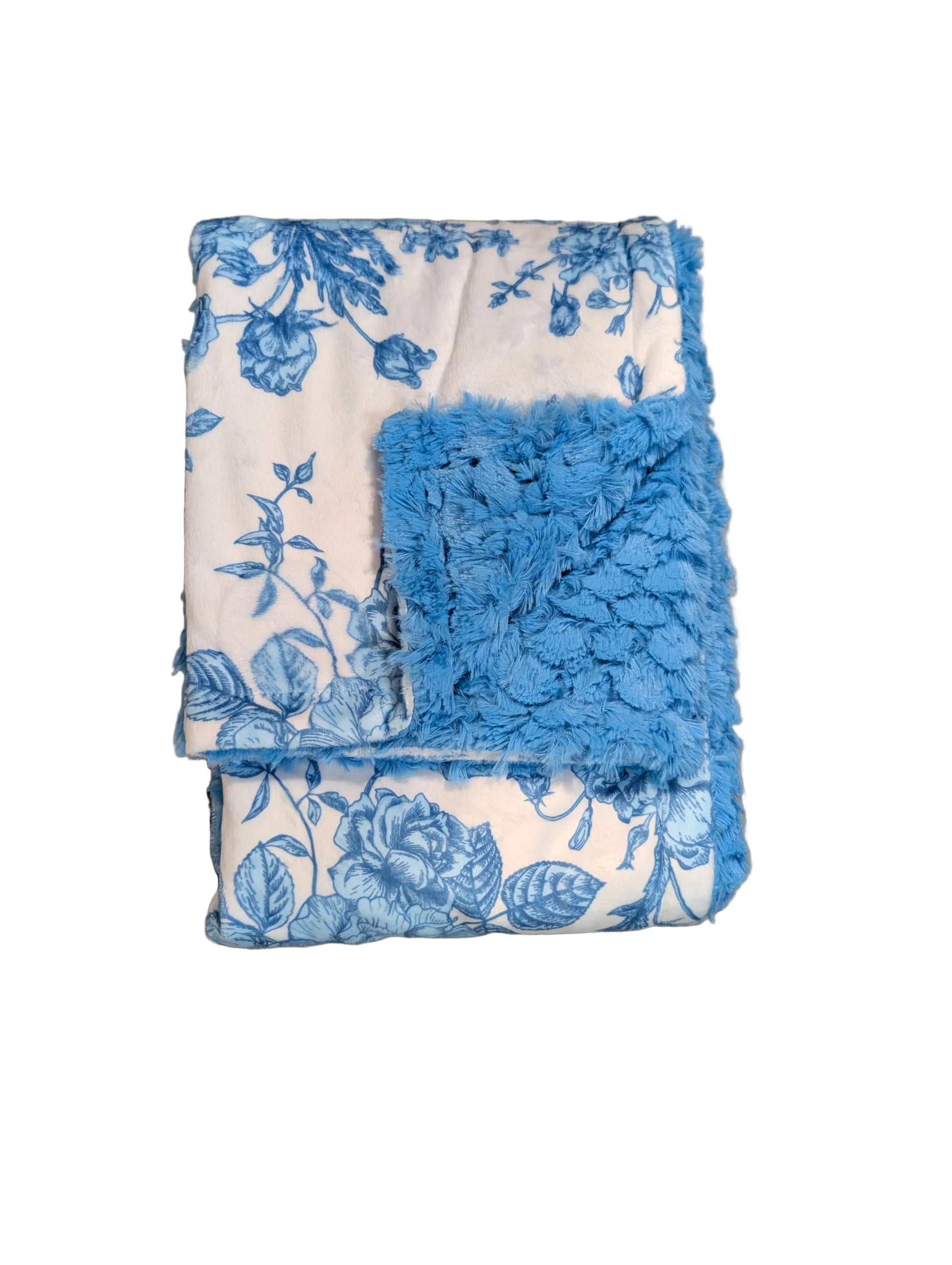 A folded throw blanket with a blue floral toile pattern on a white background and a bright blue shaggy faux-fur trim